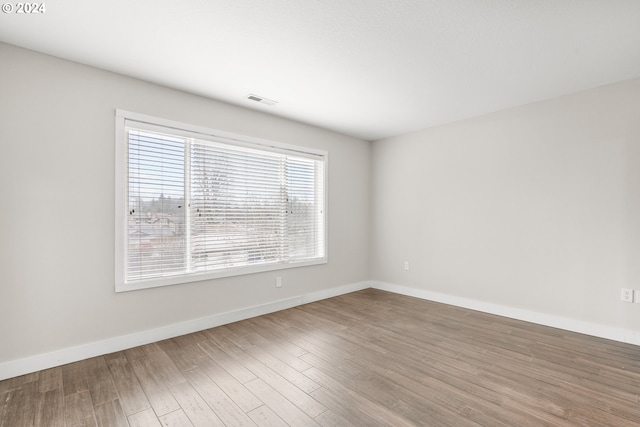 spare room with wood-type flooring