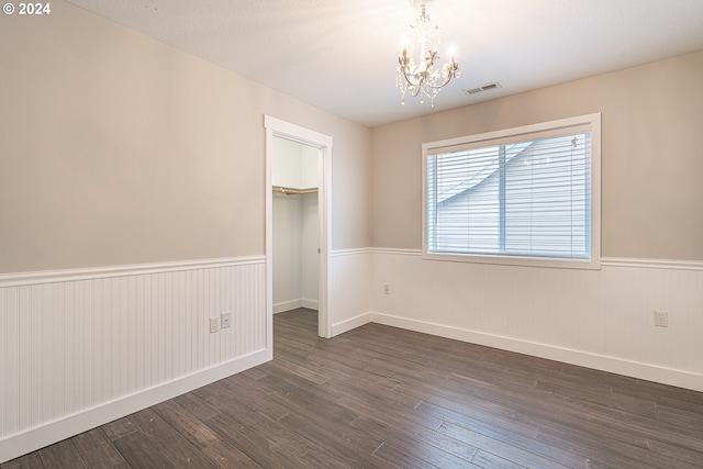 interior space with dark hardwood / wood-style floors and a notable chandelier