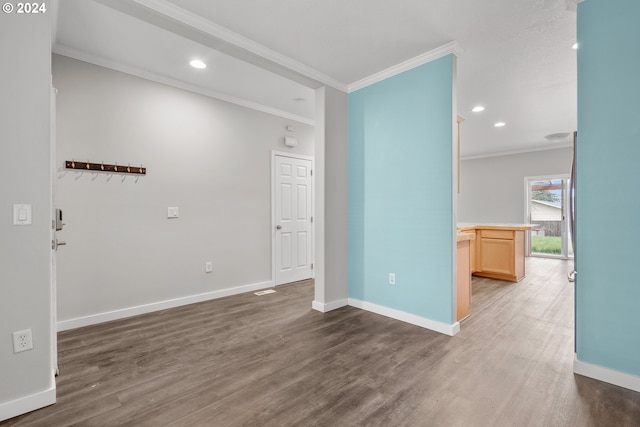 empty room with dark hardwood / wood-style flooring and ornamental molding