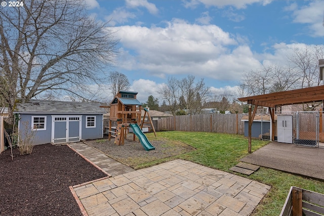 view of patio featuring a pergola, an outbuilding, and a playground