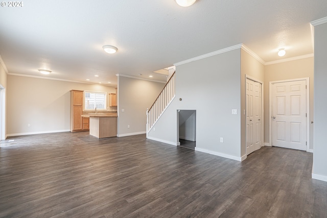 unfurnished living room with dark wood-type flooring, a textured ceiling, and ornamental molding