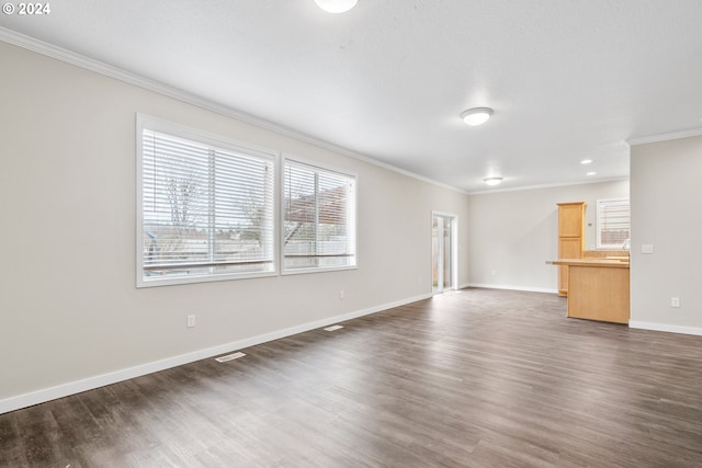 unfurnished living room with a textured ceiling, crown molding, and dark hardwood / wood-style floors