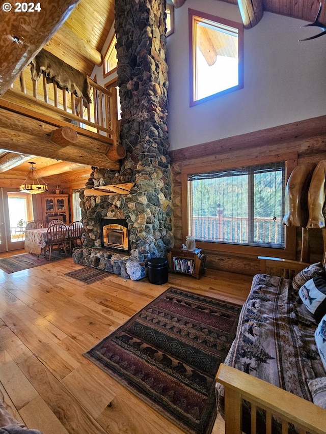 living room featuring hardwood / wood-style floors, high vaulted ceiling, wooden ceiling, and a wealth of natural light