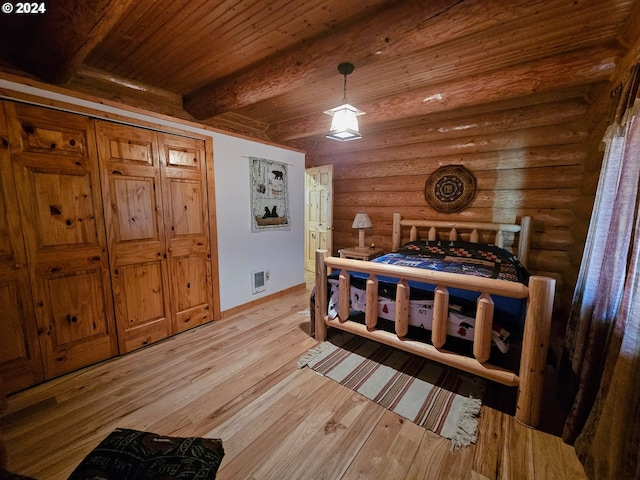 bedroom featuring rustic walls, visible vents, light wood-style floors, beamed ceiling, and wooden ceiling