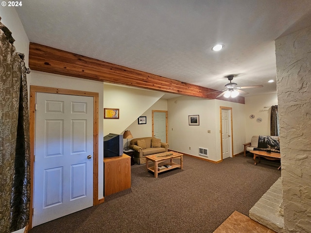 living room featuring beam ceiling, dark carpet, and ceiling fan