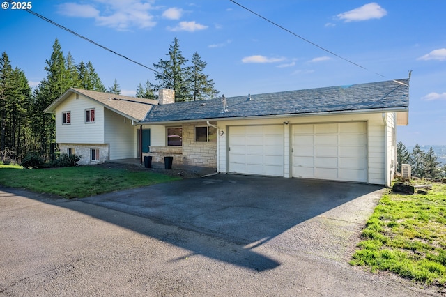 view of front of property with a front yard and a garage