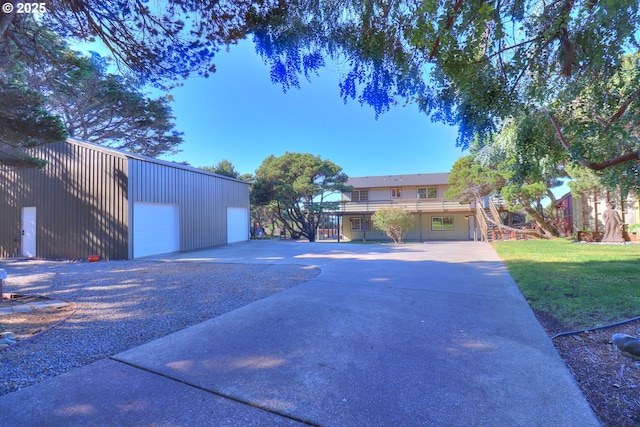 view of side of home with a yard, an outbuilding, and a garage