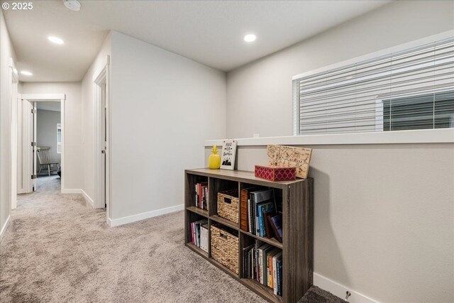 hallway featuring light carpet, baseboards, and recessed lighting