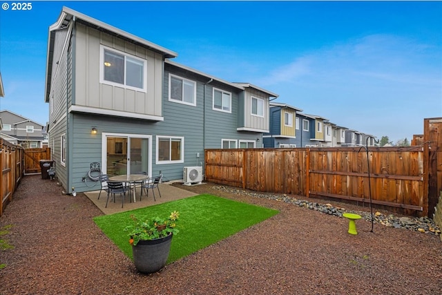 rear view of house with a patio, a fenced backyard, a residential view, ac unit, and board and batten siding