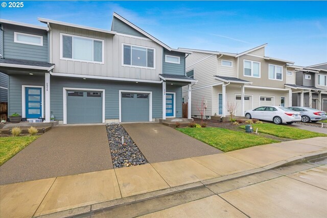 view of property with board and batten siding, a residential view, concrete driveway, and a garage