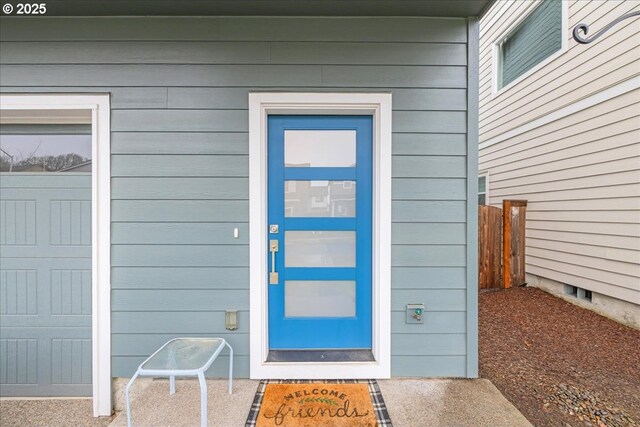 entrance to property with a garage and fence