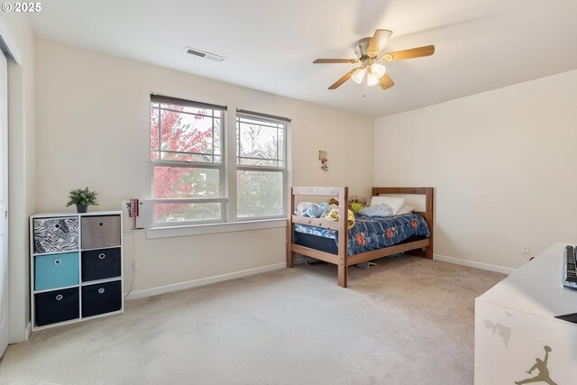 bedroom with ceiling fan and light carpet