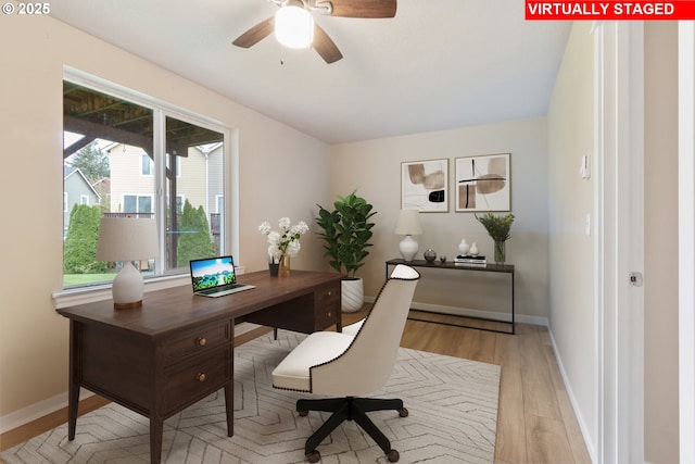 home office with light wood-type flooring, baseboards, and ceiling fan