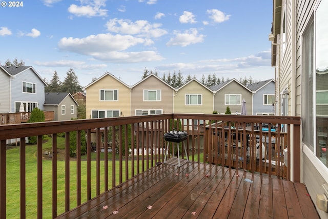 deck with a residential view and a lawn