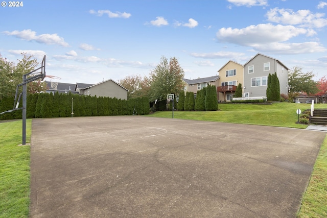 view of sport court featuring a lawn