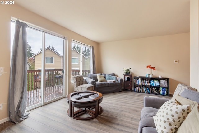 living room with a wealth of natural light and light wood-type flooring