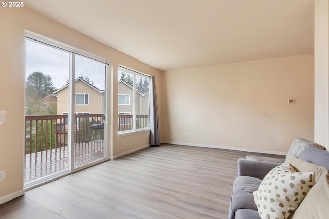 sitting room featuring light wood-style flooring and baseboards