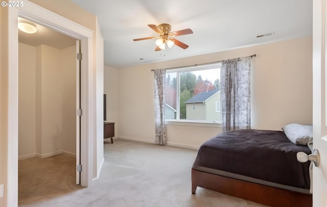 carpeted bedroom with baseboards, visible vents, and ceiling fan