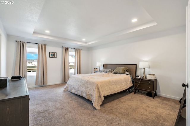 bedroom featuring recessed lighting, a raised ceiling, light colored carpet, and baseboards