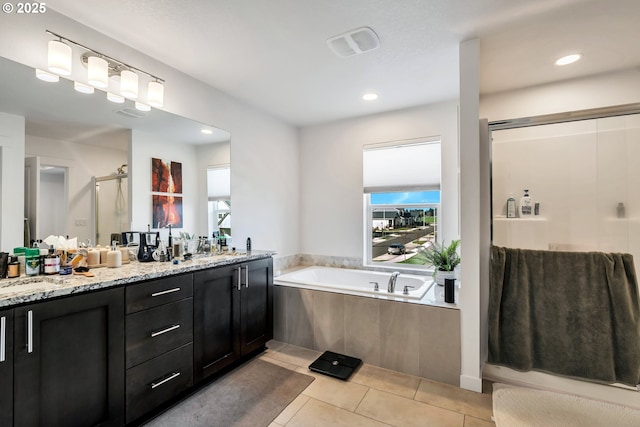 full bathroom with double vanity, a garden tub, tile patterned flooring, and a shower stall