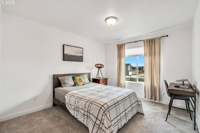 carpeted bedroom featuring baseboards