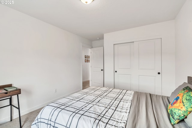 bedroom featuring a closet, carpet flooring, and baseboards