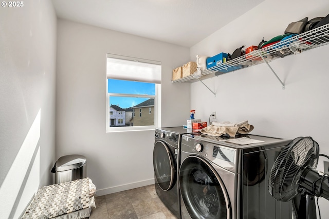 washroom with laundry area, baseboards, and separate washer and dryer