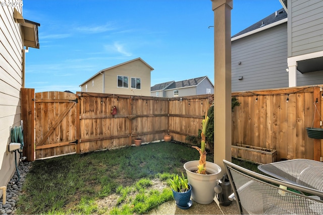 view of yard with fence and a gate