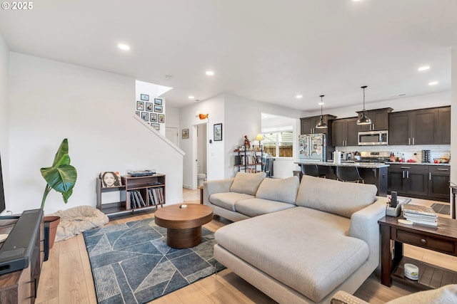 living area with light wood finished floors and recessed lighting