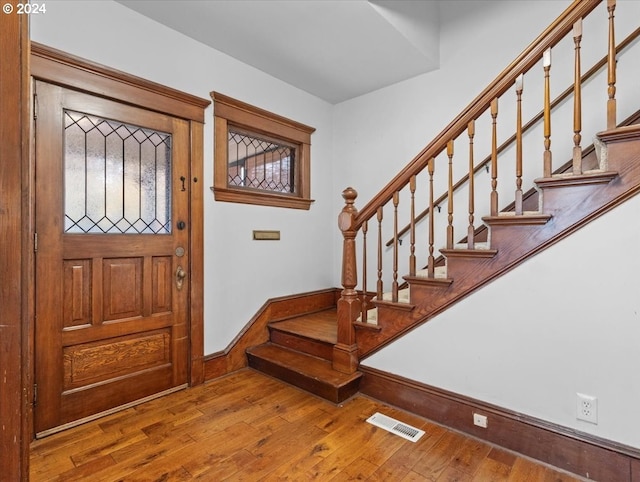 entryway with hardwood / wood-style flooring