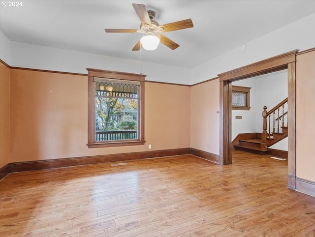 empty room with light hardwood / wood-style floors and ceiling fan