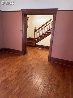 unfurnished room with hardwood / wood-style floors