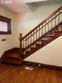 staircase featuring hardwood / wood-style flooring