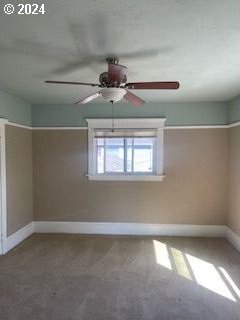 carpeted empty room with ceiling fan