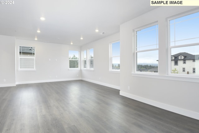 empty room with dark hardwood / wood-style flooring