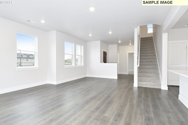 unfurnished living room featuring dark hardwood / wood-style floors