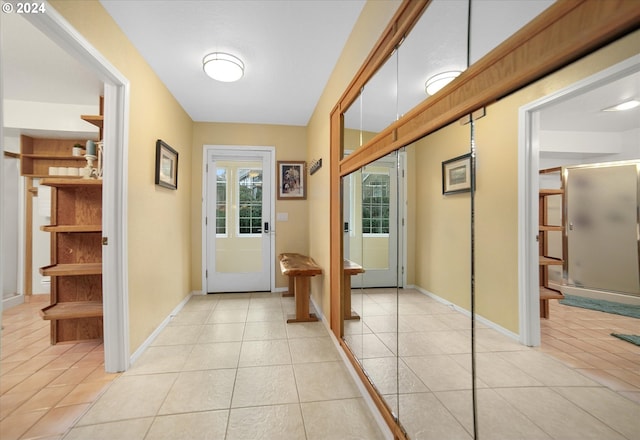 doorway with light tile patterned flooring