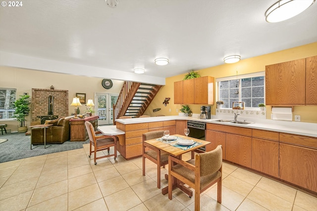 kitchen featuring sink, light tile patterned floors, and dishwasher