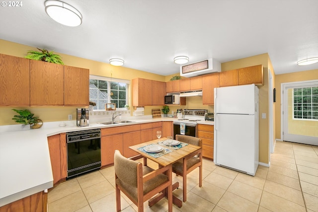 kitchen featuring light tile patterned flooring, white appliances, and sink