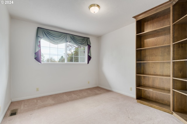 unfurnished room featuring carpet