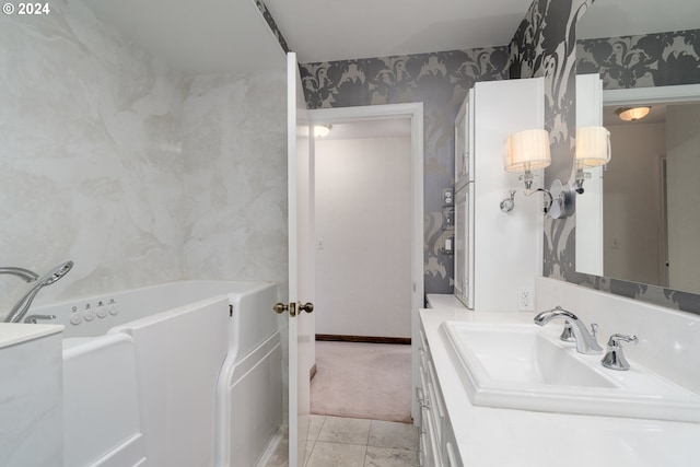 bathroom with vanity and a washtub