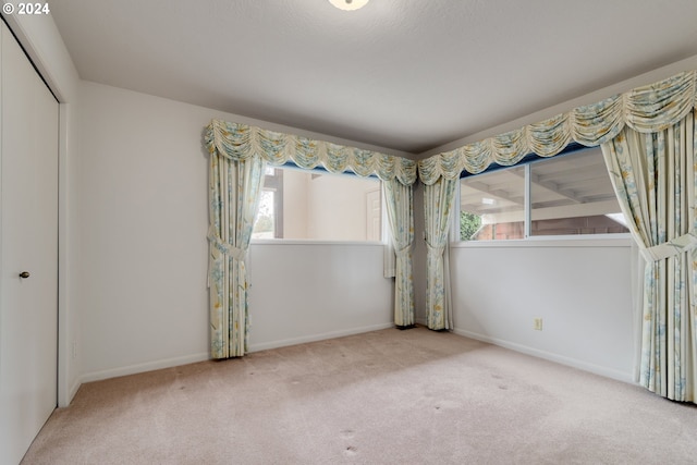 unfurnished bedroom featuring a closet and carpet flooring