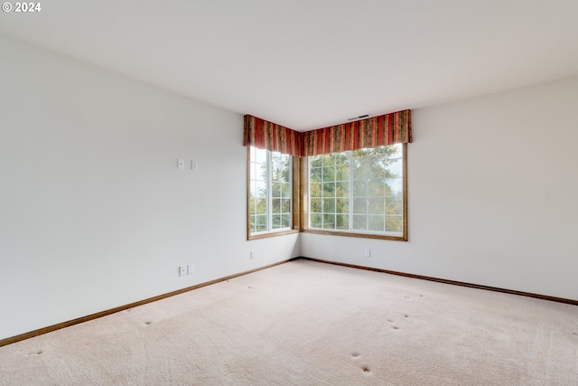 empty room featuring light carpet