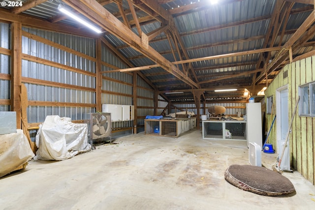 miscellaneous room with concrete floors and vaulted ceiling