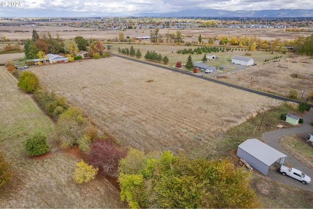 birds eye view of property featuring a mountain view and a rural view