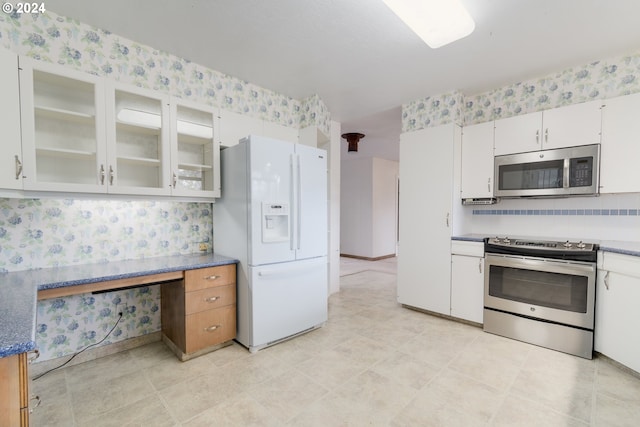 kitchen with appliances with stainless steel finishes and white cabinets