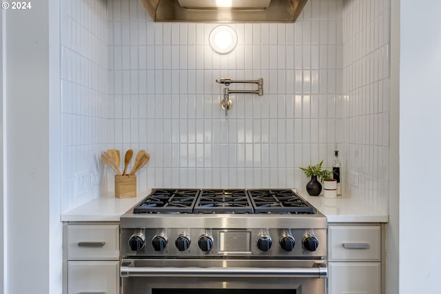 kitchen featuring high end range and tasteful backsplash