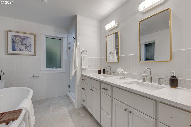 bathroom featuring vanity, tile patterned floors, separate shower and tub, and tile walls