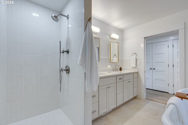 bathroom featuring vanity, hardwood / wood-style floors, and tiled shower