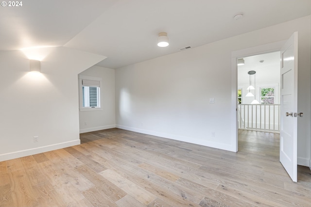 unfurnished room with light wood-type flooring